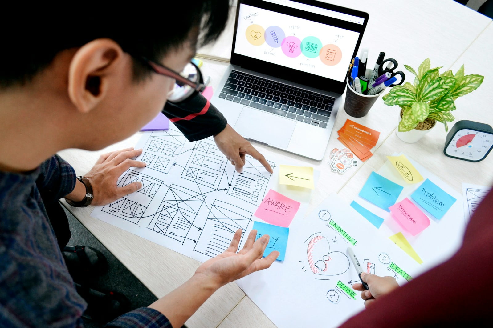 woman in black long sleeve shirt holding white paper doing research