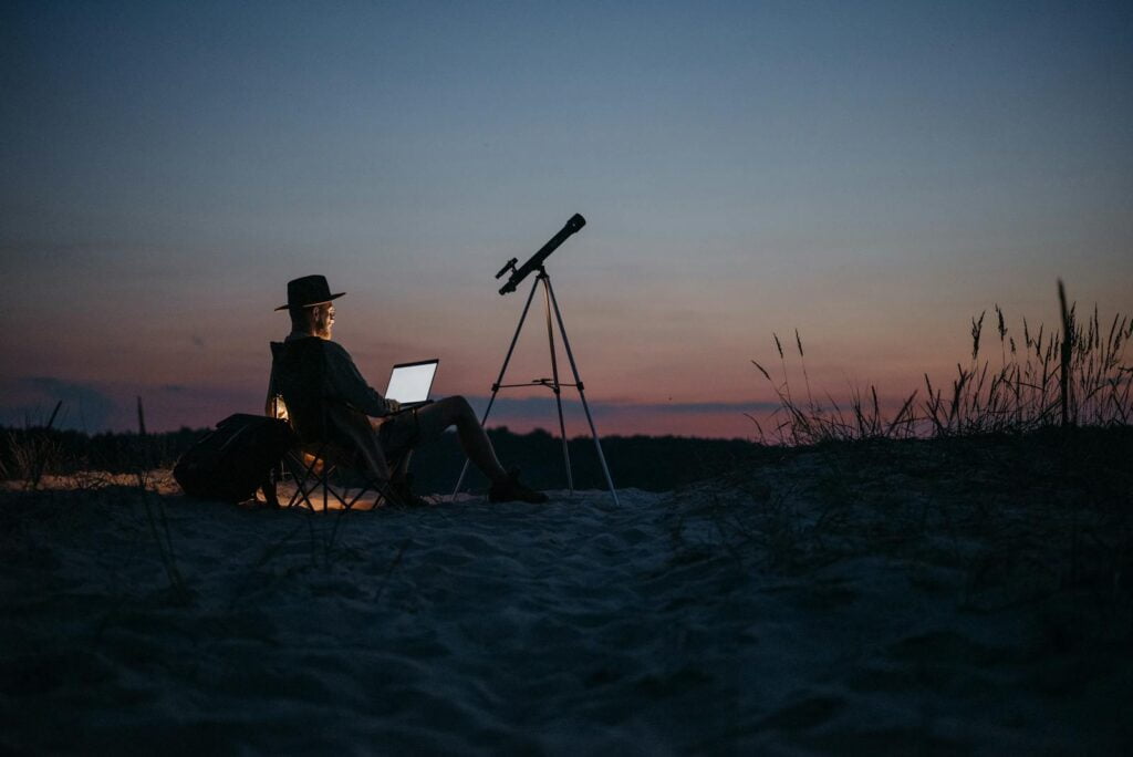 A Person Using a Laptop Outside at Night